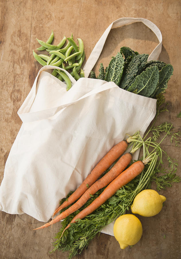 Studio shot of organic vegetables in shopping bag Photograph by Jamie Grill