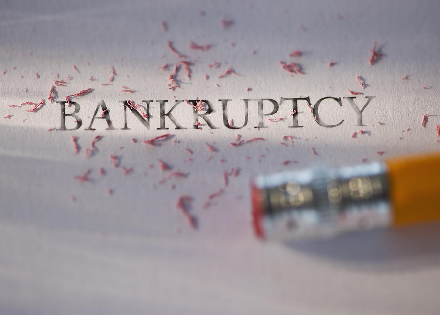 Studio shot of pencil erasing the word bankruptcy from piece of paper Photograph by Daniel Grill