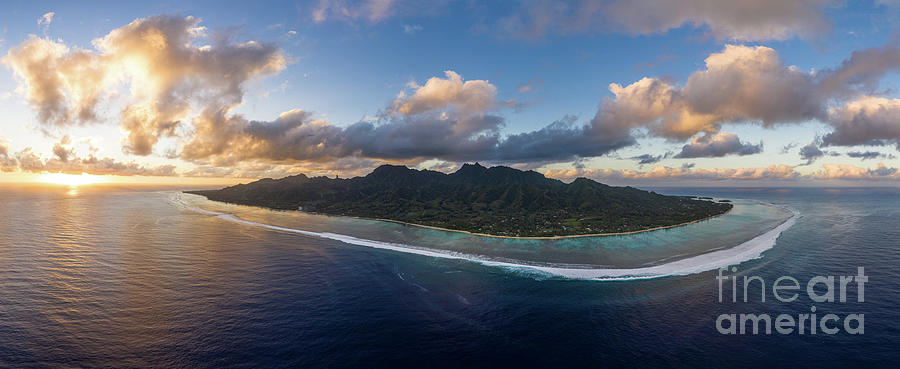 Stunning sunset as an aerial panorama of the Rarotonga island in Photograph by Didier Marti
