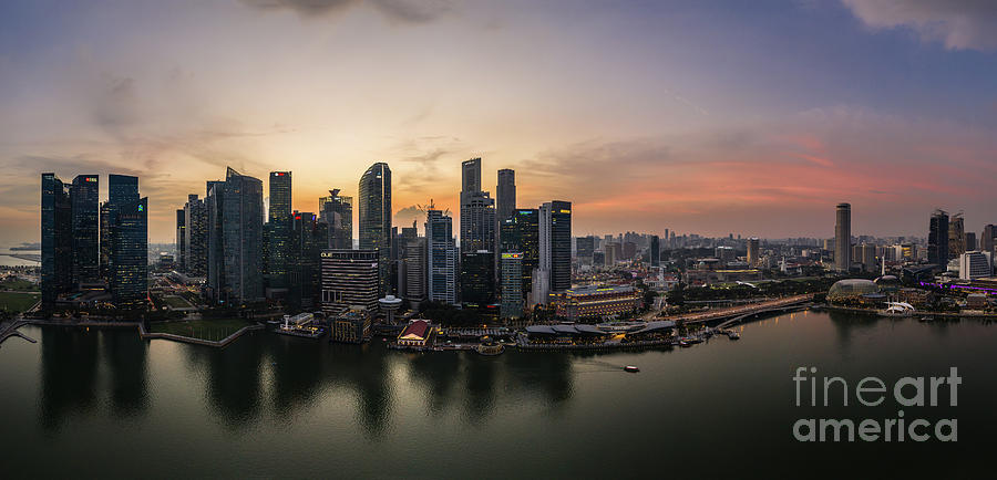 Stunning sunset over the famous Singapore skyline by the Marina  Photograph by Didier Marti