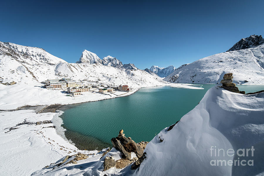 Stunning view of the turquoise colored Gokyo lake and village on Photograph by Didier Marti