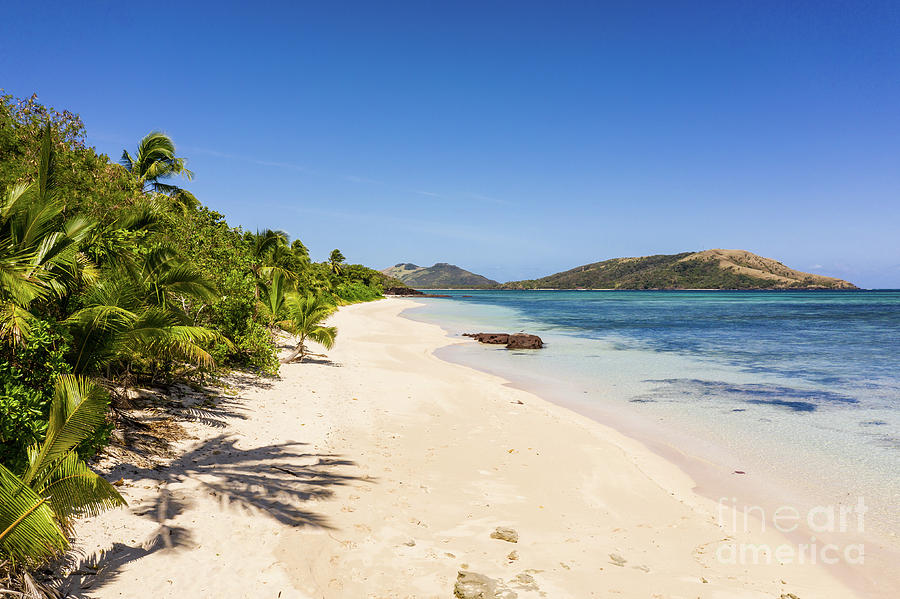 Stunning white sand beach by the blue lagoon in the Yasawa islan Photograph by Didier Marti