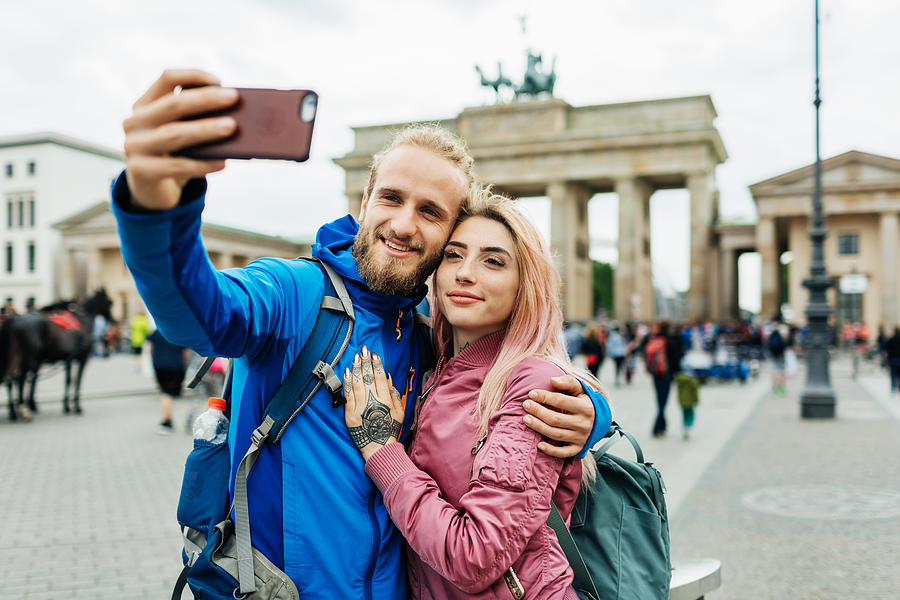 Stylish Young Couple Take A Selfie In Front Of Local Architecture Photograph by Hinterhaus Productions
