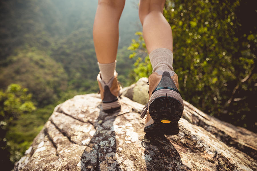 Successful hiker enjoy the view on mountain top cliff edge Photograph by Lzf