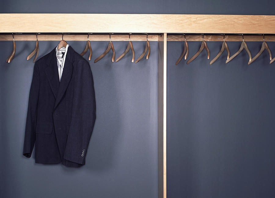 Suit jacket and shirt hanging in office cubby Photograph by Erik Von Weber
