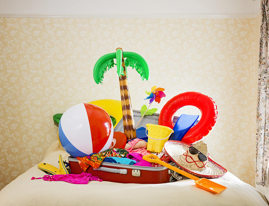 Suitcase Full Of Inflatable Holiday Props On Bed Photograph by Jw Ltd
