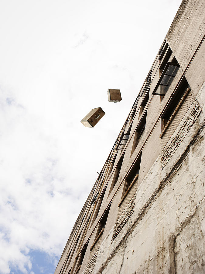Suitcases Being Thrown From A Building Photograph by Thomas Northcut