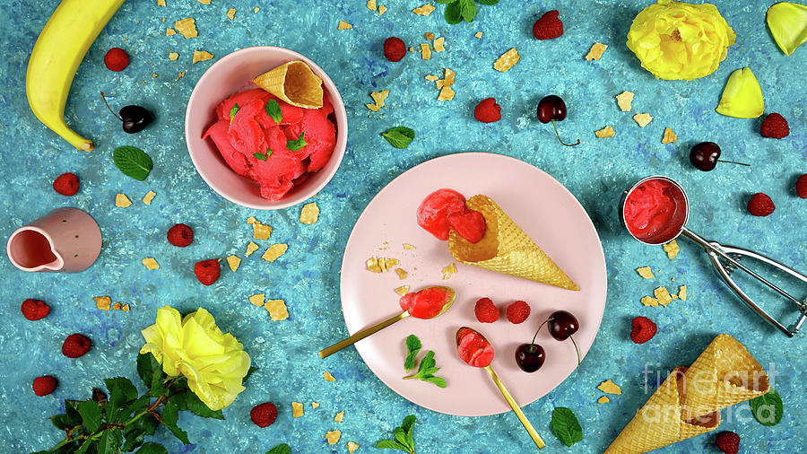 Summer ice cream berry sorbet preparation with waffle cones and fresh berries. Photograph by Milleflore Images