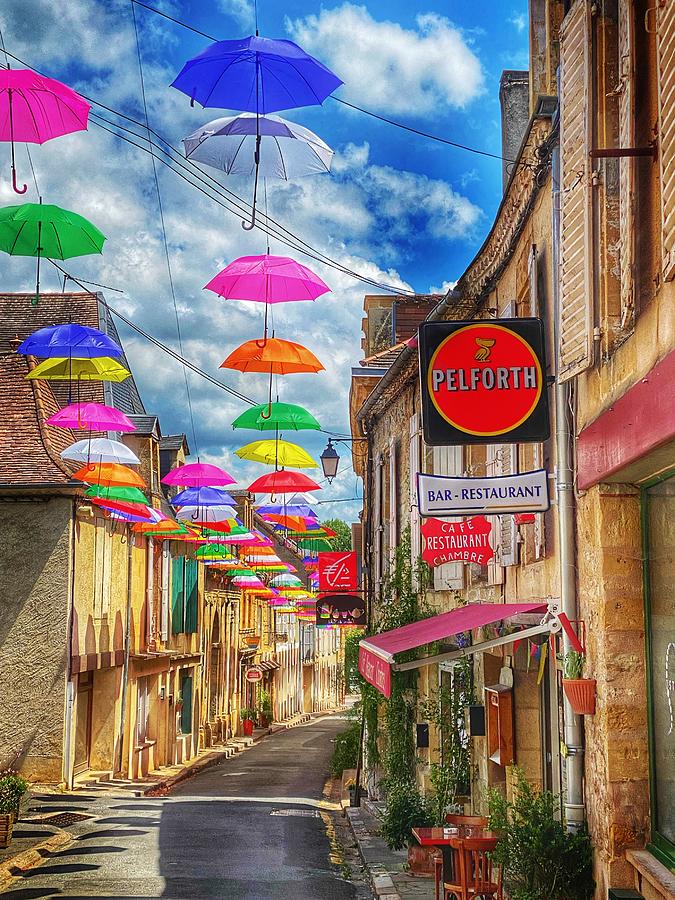 Summer parasols  in Excideuil, France Photograph by Chris Clark