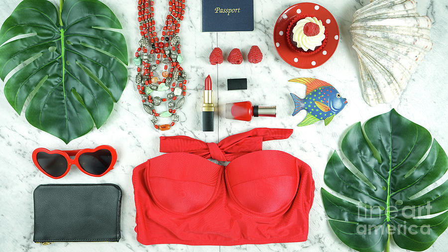 Summer vacation concept flatlay with red feminine accessories. Photograph by Milleflore Images