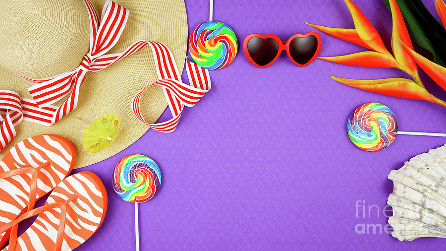 Summer vacation theme flatlay overhead on purple background. Photograph by Milleflore Images