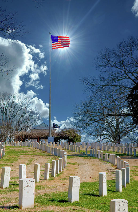 Sun Behind Flag at Cemetery Photograph by Darryl Brooks