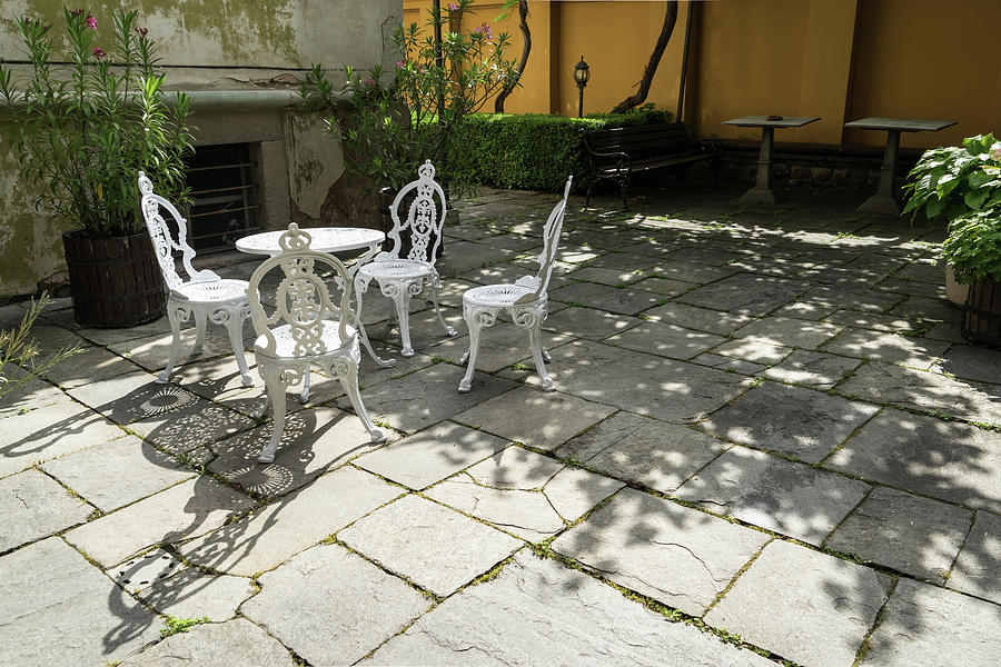 Sun Dappled Invitation - Ubercharming Courtyard with Elegant Cast Iron Furniture Photograph by Georgia Mizuleva