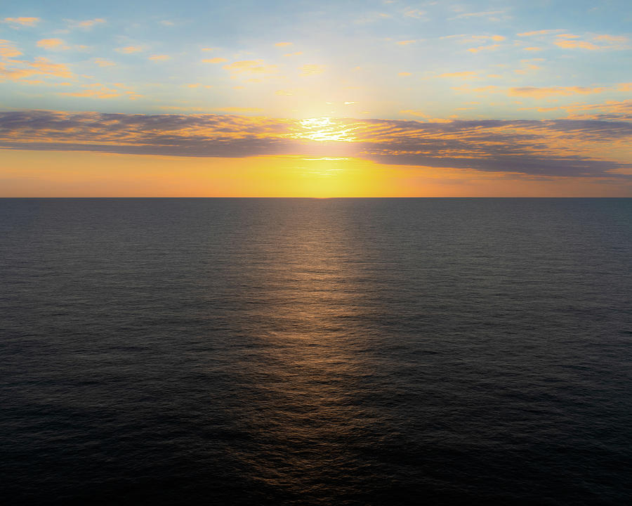 Sun Hidden Behind Clouds Shines Across the Sea Photograph by William Dickman