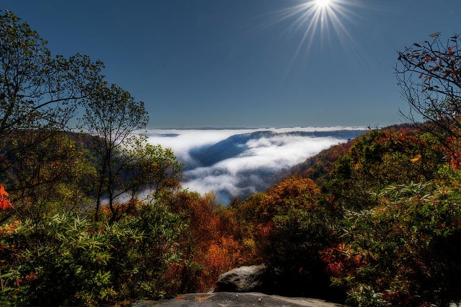 Sun lighting the fog filled valley  Photograph by Dan Friend