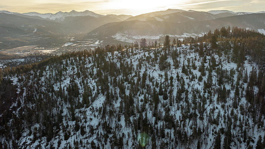 Sun peaking through the mountains  Photograph by John McGraw