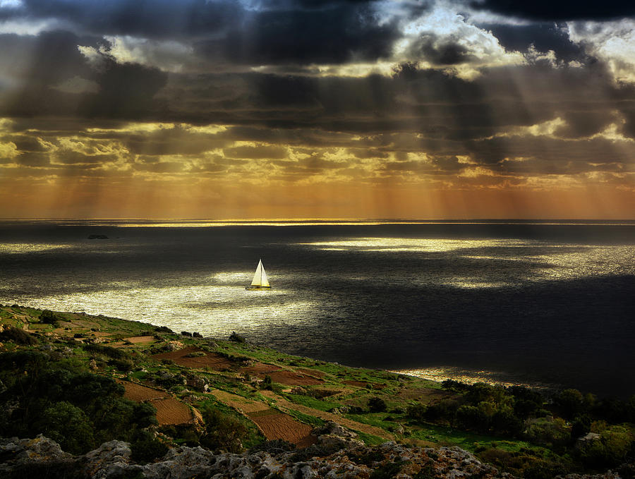Sun rays on sea at sunset with cliffs - Landscape photo Photograph by Stephan Grixti