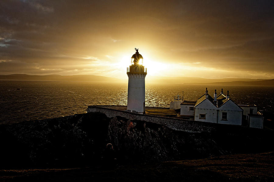 Sun setting over Bressay Lighthouse Photograph by Tony Mills
