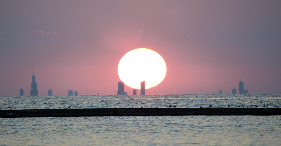 Sun Settting Behind the Chicago Skyline from Michigan City, Indi Photograph by Peter Ciro