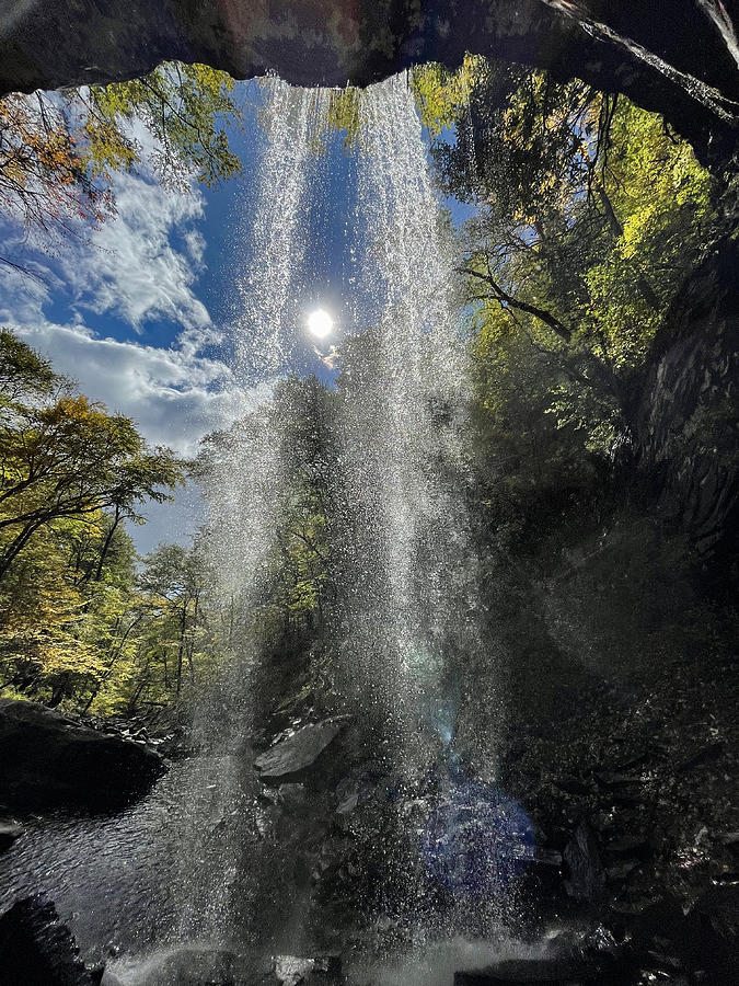 Sun shining through a waterfall Photograph by Dan Friend