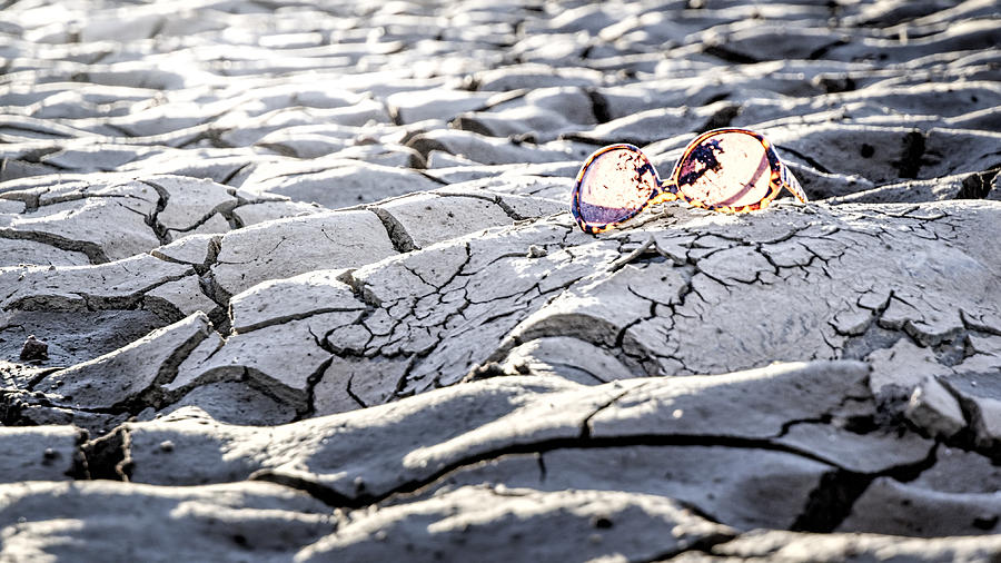 Sunglasses on mud Photograph by Chris Flores / FOAP