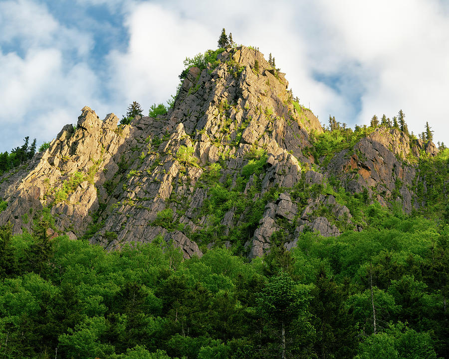 Sunlight plays on a Stone Pinnacle in Dixville Notch, New Hampshire Photograph by William Dickman