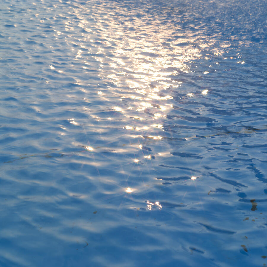 Sunlight reflected on water surface Photograph by Mixa