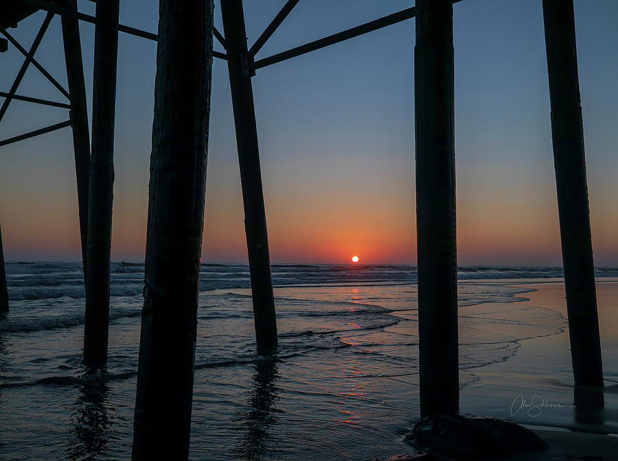 Sunset Photograph - Sunlight Shooting Through Pier  by Alice Schlesier