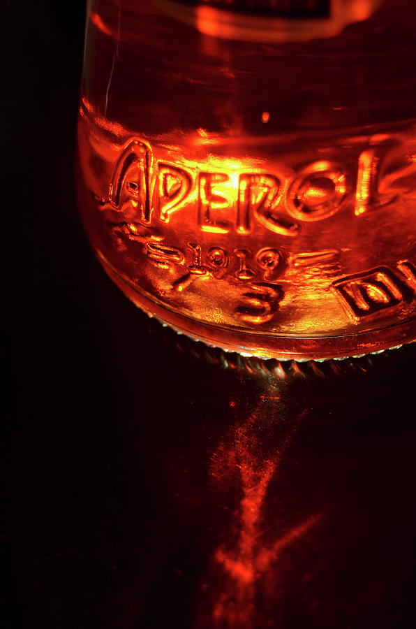 Sunlit Aperol Aperitif Glass Bottle with Sun Flare Macro Photograph by Shawn OBrien
