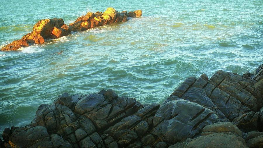 Sunlit rocks on the sea Photograph by Robert Bociaga