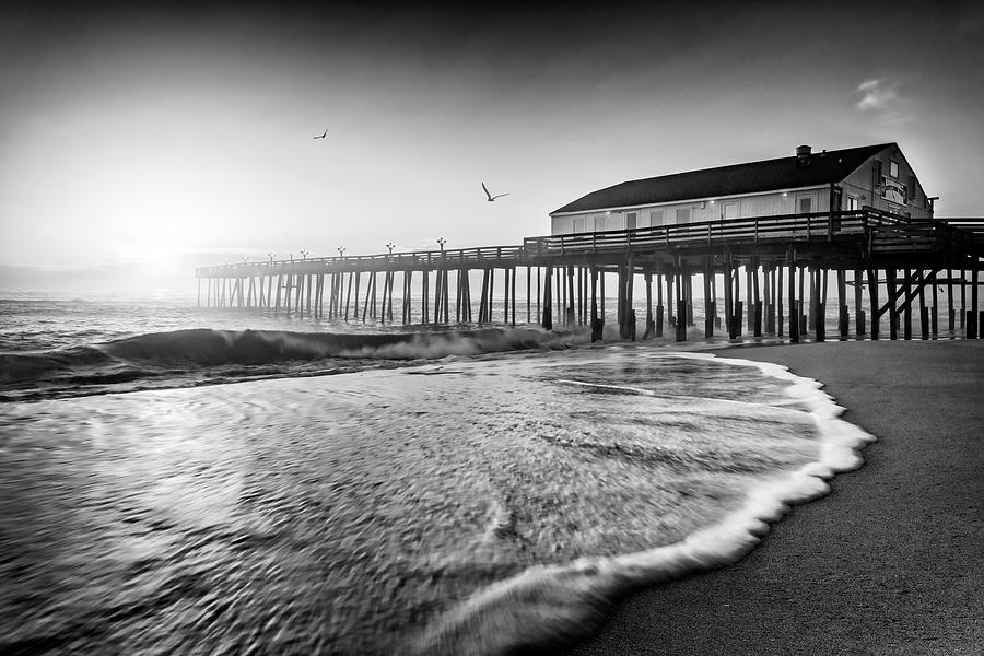 Black And White Photograph - Sunrise at Kitty Hawk Pier Black and White by Rick Berk
