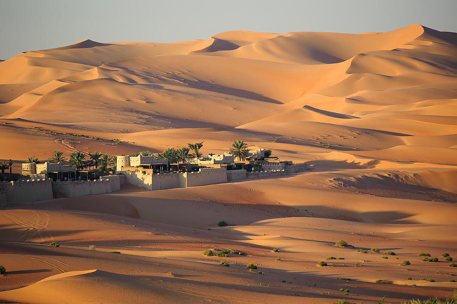 Sunrise at the Qasr Al-Sarab desert resort near Liwa, United Arab Emirates. The luxury resort is nestled in the dunes of the Empty Quarter - a part of the Arabian Desert which covers much of the peninsula. Photograph by by Marc Guitard