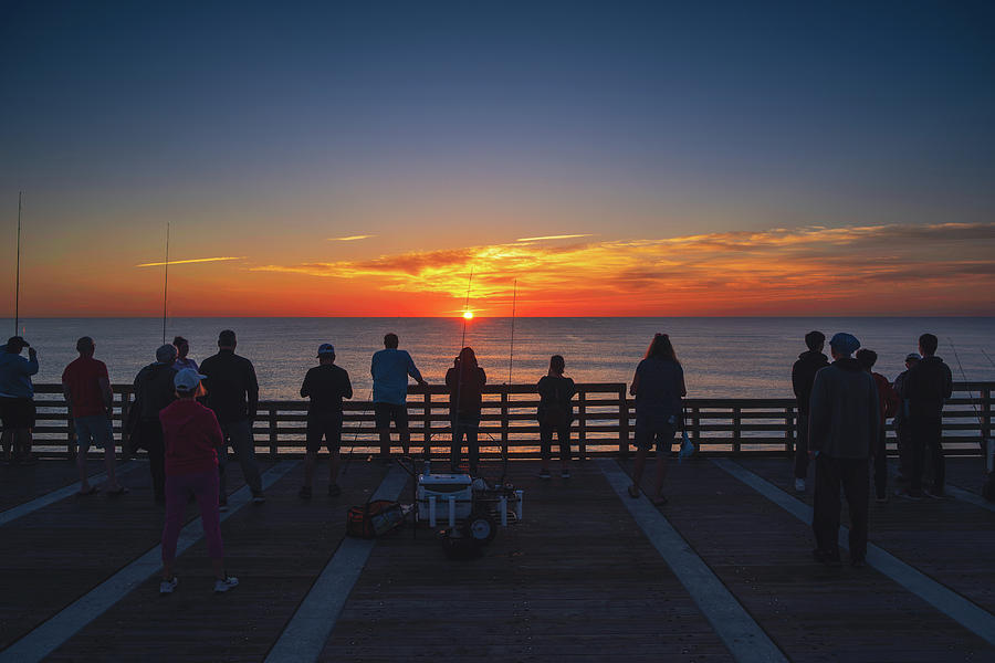 Sunrise Gathering at Jacksonville Beach Pier Photograph by Kim Seng