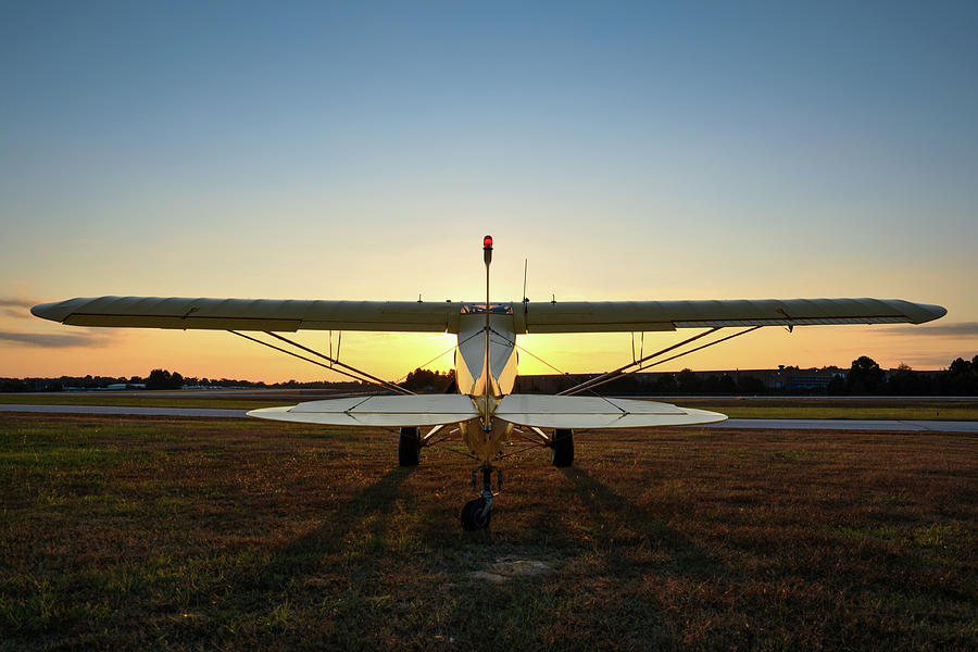 Sunrise on a yellow Piper Cub Photograph by Chris Buff