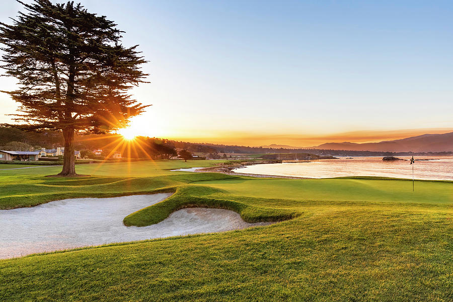 Sunrise on hole 18 at Pebble Beach Golf Course Photograph by Mike Centioli