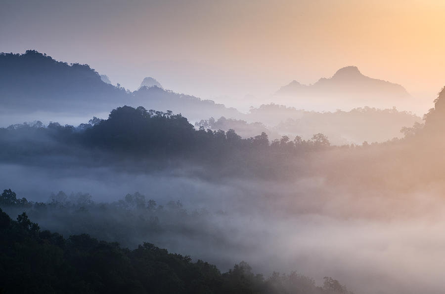 Sunrise on the Mountain with moving mist for nature background Photograph by Arutthaphon Poolsawasd