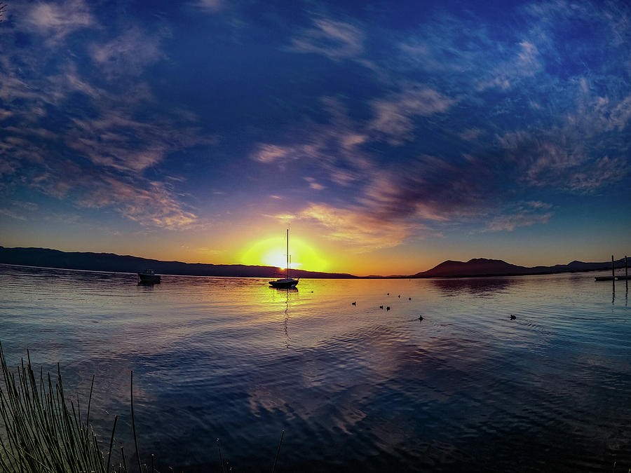 Sunrise over the lake with sailboats Photograph by Devin Wilson