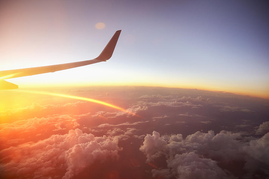 Sunrise over the world from a plane window. Photograph by Oli Kellett
