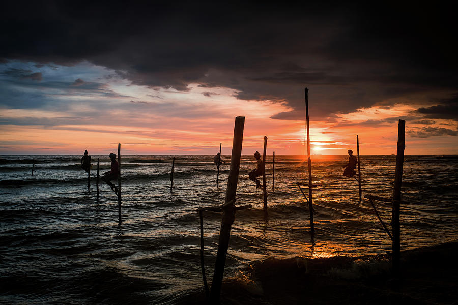 Sunset and Stilt Fishermen Photograph by Arj Munoz