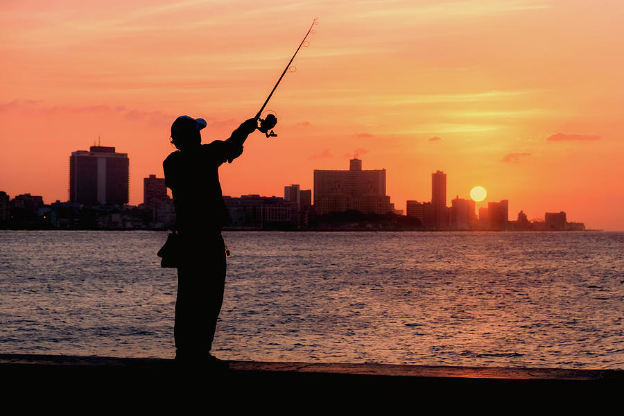 Sunset in Havana with the silhouette of a fisherman Photograph by Karel Miragaya