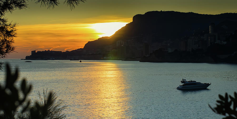 Sunset in Monaco from Cap Martin with yacht and dark cliffs Photograph by Jean-Luc Farges