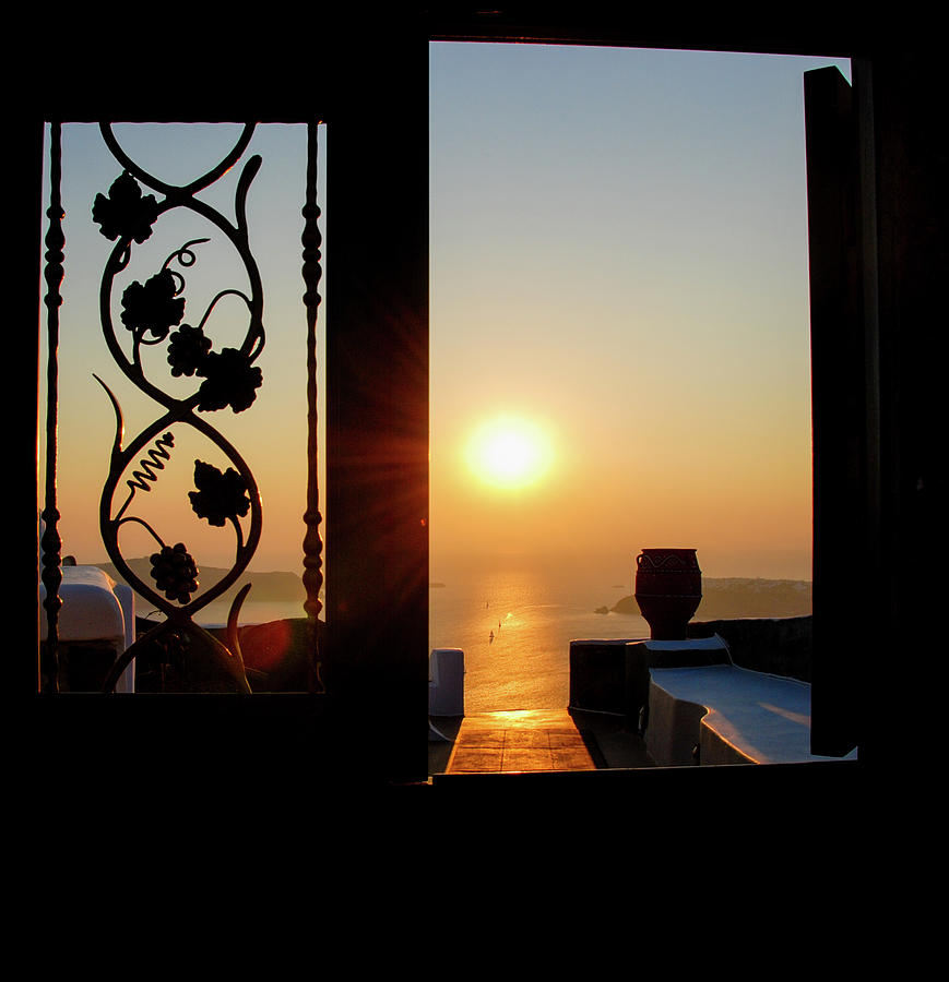 Sunset in the aegean sea from a house. Santorini island Greece. Photograph by Michalakis Ppalis