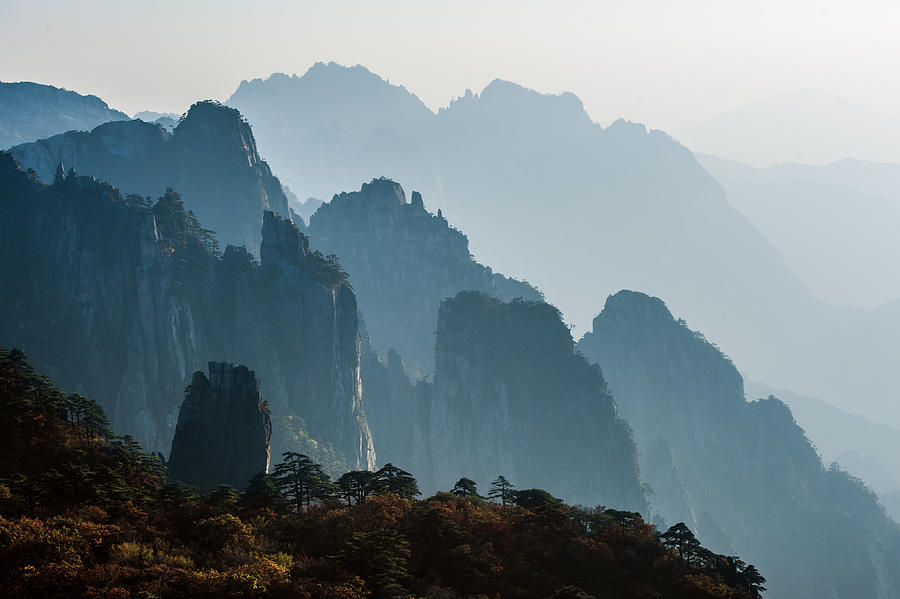 Sunset in the Huangshan Mountain Range - Anhui Province, China. Evening sun lights the cliffs below and observation deck. Photograph by Oleksandra Korobova