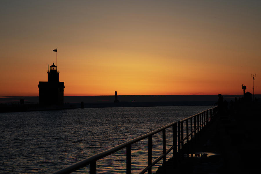 Sunset in winter at the Holland Michigan Lighthouse along Lake Michigan Photograph by Eldon McGraw