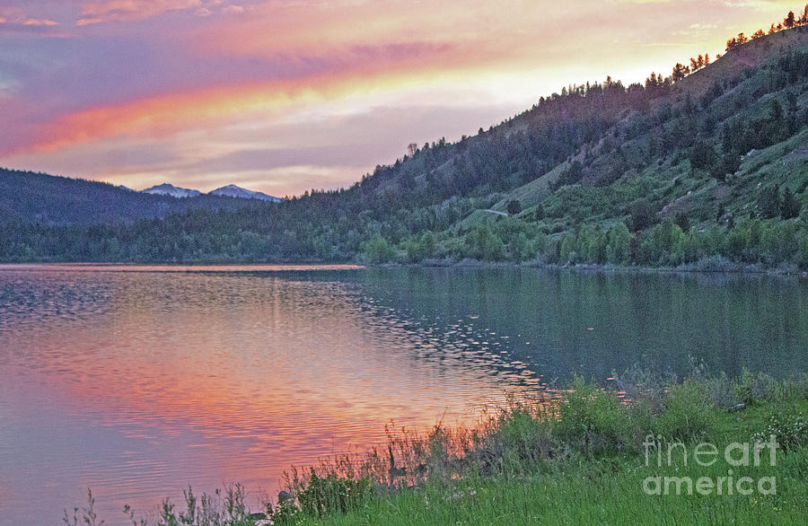 Sunset on a lake Photograph by John Langdon