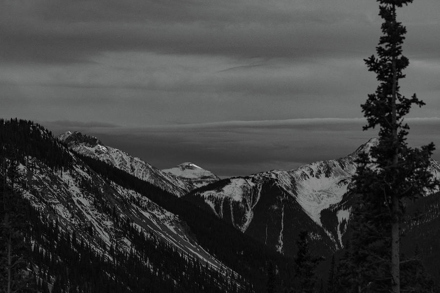 Sunset on the peaks of Rocky Mountains along Million Dollar Highway in black and white Photograph by Eldon McGraw