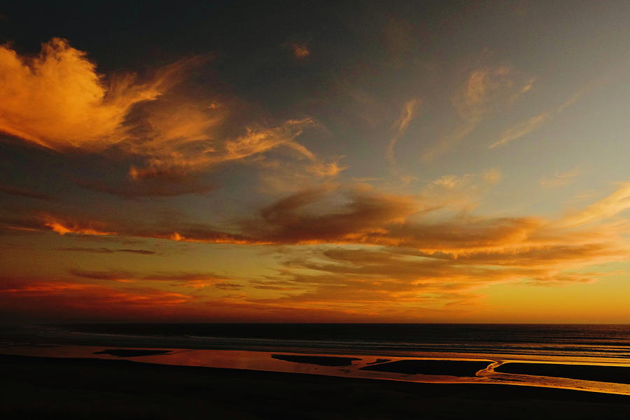 Sunset over the Pacific Ocean beach  Photograph by Brent Bunch