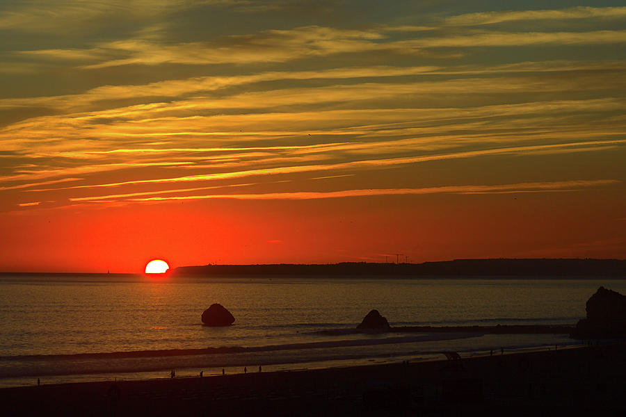 Sunset over the sea at Praia da Rocha Photograph by Jeremy Hayden
