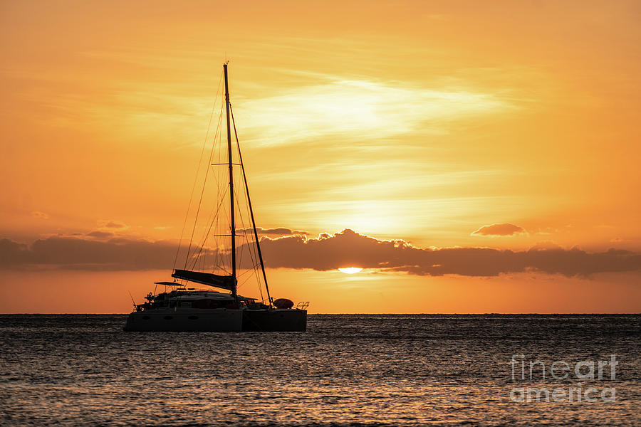 Sunset over two catamaran sailboat off the Yasawa island in Fiji Photograph by Didier Marti