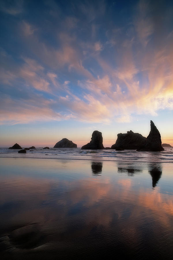 Sunset silhouette reflections of offshore Face Rock at Bandon Beach ...